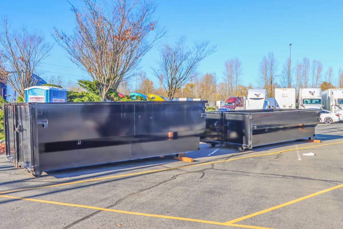 Professional dumpster rental service with roll-off container on residential driveway in Tillamook